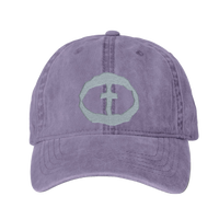Front view of the violet Cassie Women's Ponytail Cap with a light-gray embroidered circular cross logo, product shot on white.
