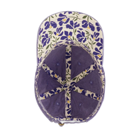 Interior view of the violet Cassie Women's Ponytail Cap showing the cream floral underbrim and seam tape, product shot on white.