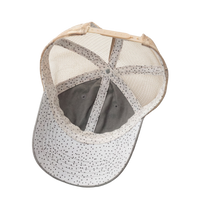 Interior view of the light grey Tess Women's Ponytail Cap showing the polka-dot underbrim, tan mesh, and ponytail opening, product shot on white.