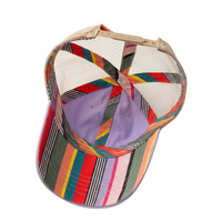 Interior view of the lavender Tess Women's Ponytail Cap showing the colorful striped underbrim, tan mesh, and ponytail opening, product shot on white.