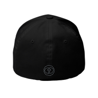 Back view of the black Flexfit Men's Cap with a small outlined light-gray circular cross logo at the nape, product shot on white.