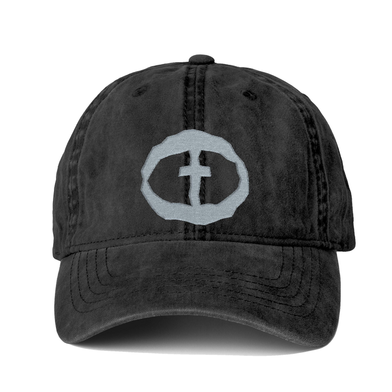 Front view of the washed-black Cassie Women's Ponytail Cap with a light-gray embroidered circular cross logo, product shot on white.