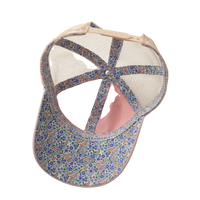 Interior view of the dusty pink Women's Ponytail Cap showing the floral underbrim, tan mesh, and ponytail opening, product shot on white.