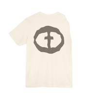 Front view of the natural Men's Rock and Salvation Lightweight Tee with a large gray rock-textured circular cross logo on the chest, ghost-mannequin on white.